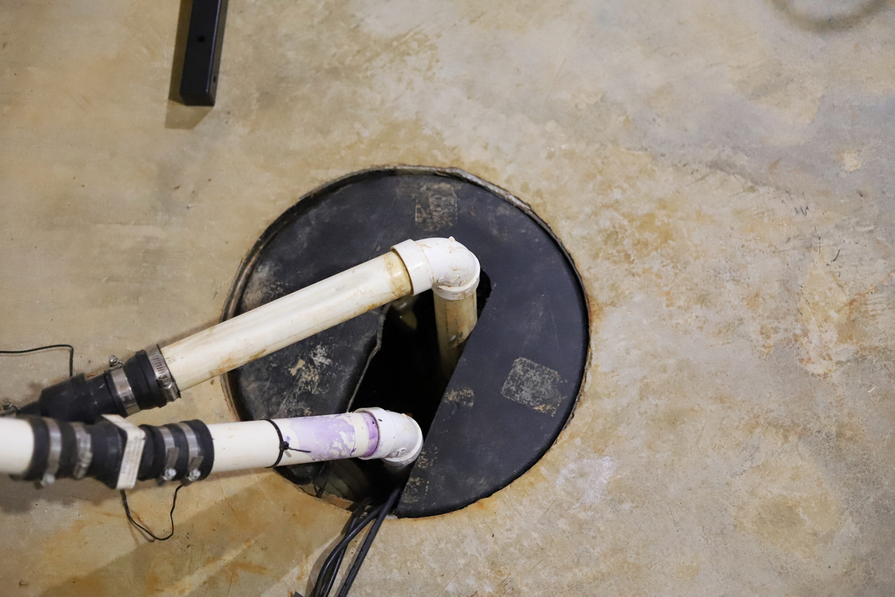 Sump pump pumping out water to prevent basement flooding